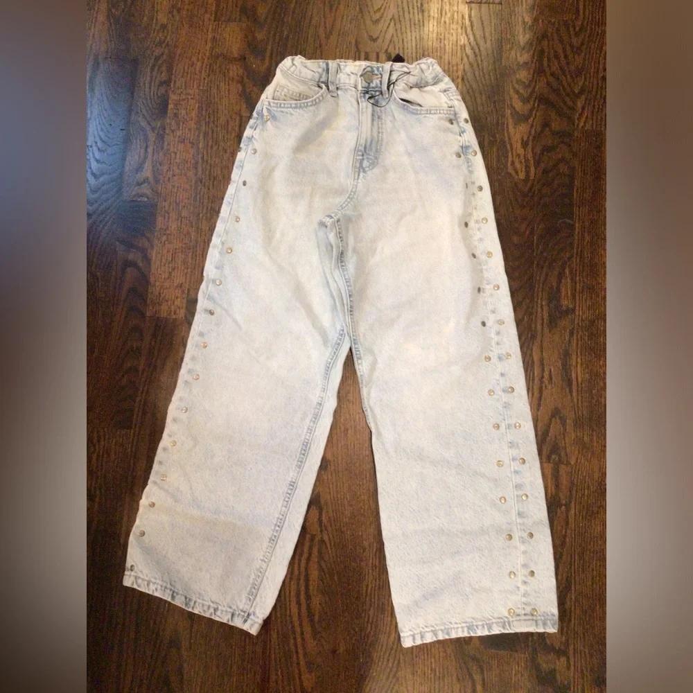 Primark - light-wash wide-leg jeans featuring side metal stud details.
